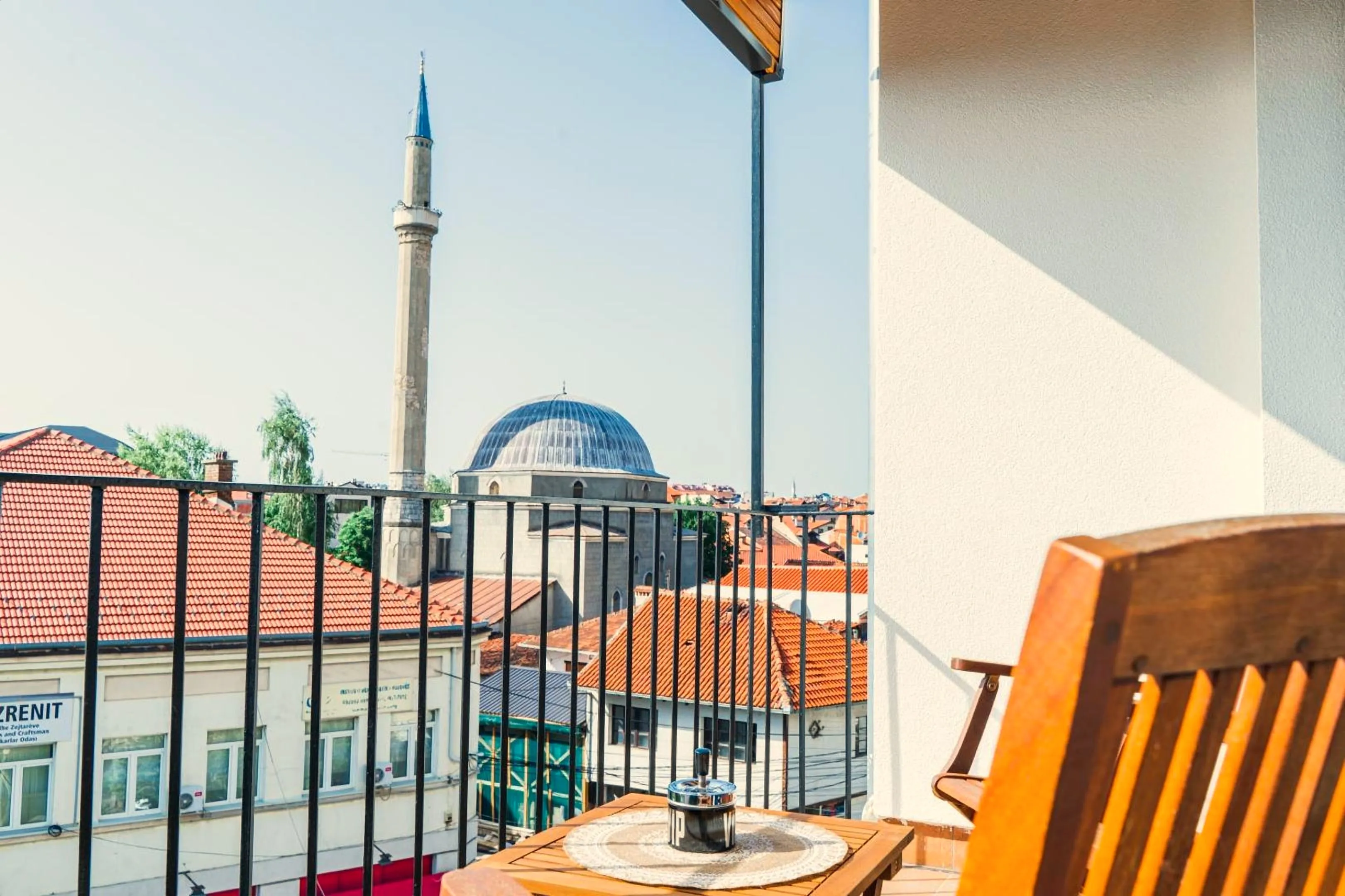 The balcony of Nani Apartment in the morning: a minaret and terracotta roofs of the old town of Prizren